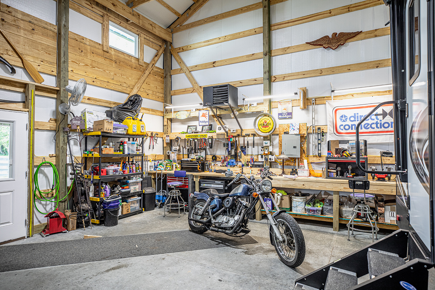 summer shield metal building insulation inside of garage with motorcycle and work bench